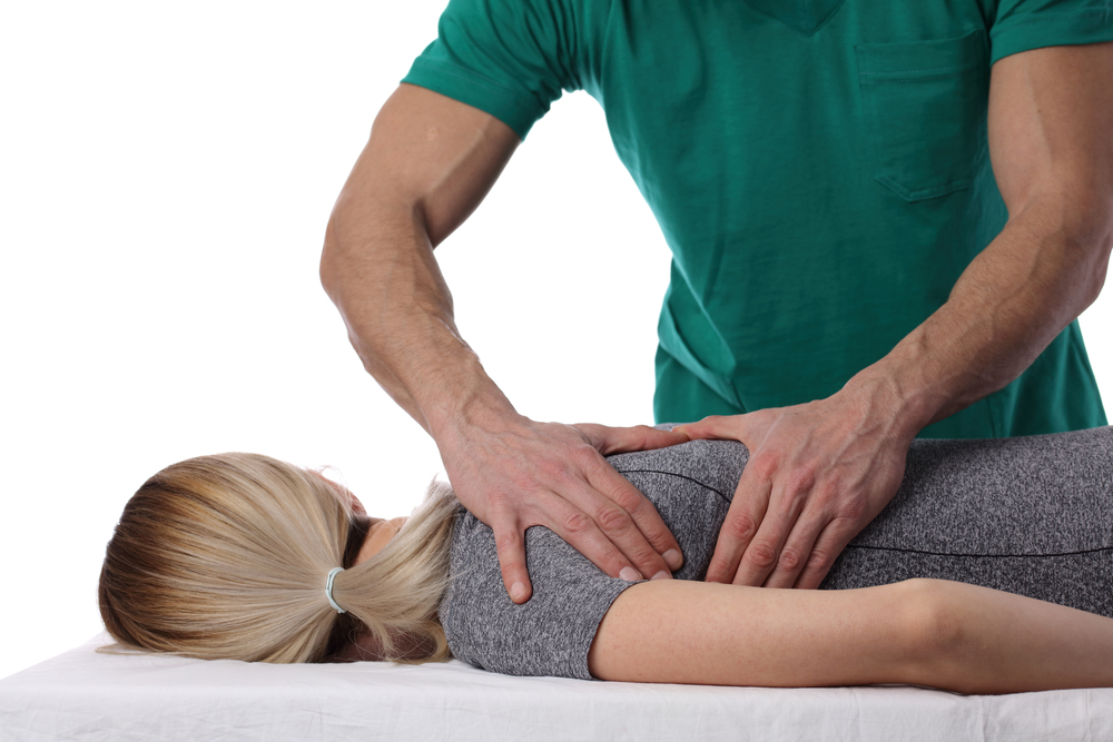 Chiropractor adjusting patients back